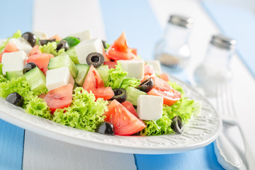 Fresh Greek salad with black olives, feta cheese and lettuce