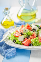 Healthy Greek salad with black olives, feta cheese and lettuce