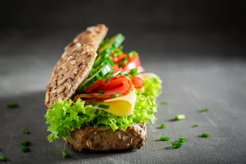 Foto op Plexiglas Tasty sandwich with cheese, ham and cucumber for breakfast © shaiith
