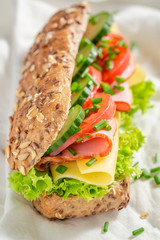 Delicious roll with cheese, ham and cucumber for breakfast