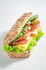 Delicious roll with ham, cheese and tomato for breakfast