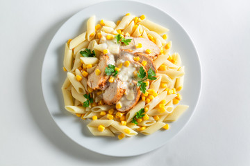 Delicious penne with bechamel sauce, chicken and corn