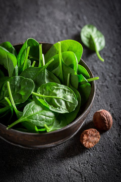 Healthy green spinach on gray old stone