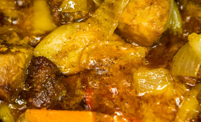 Roast meat, onions, carrots and spices, boiling in oil