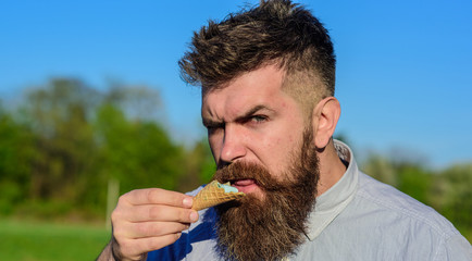 Sweet tooth concept. Bearded man with ice cream cone. Man with beard enjoy ice cream. Man with...