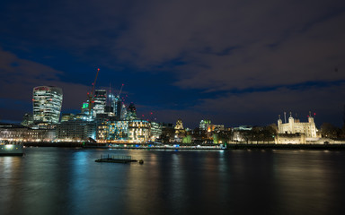 Fototapeta na wymiar The City of London with the Tower of London at night