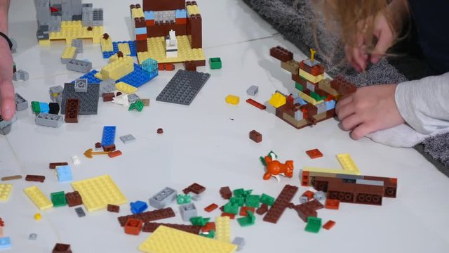 father with daughter playing with a constructor
