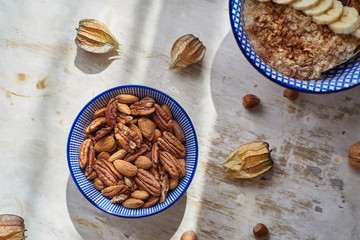 Mix of Nuts in a white-blue bowl on a light background