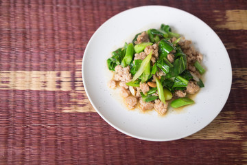 Stir fried kale with minced pork in white plate