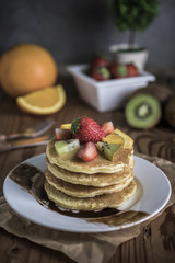 Buckwheat pancakes with berry fruit and honey.