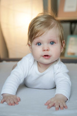 Fototapeta premiumPortrait of little adorable baby lying on the bed