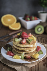 Buckwheat pancakes with berry fruit and honey.