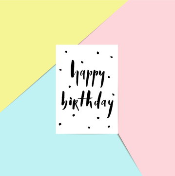Happy birthday - brush lettering card on a pink, blue and yellow