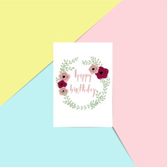 Happy birthday - brush lettering card on a pink, blue and yellow