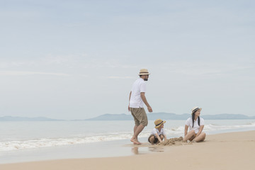 happy family with two kids on the beach,