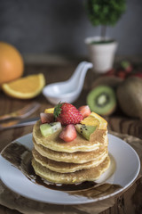 Buckwheat pancakes with berry fruit and honey.