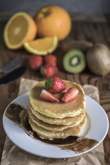 Buckwheat pancakes with berry fruit and honey.