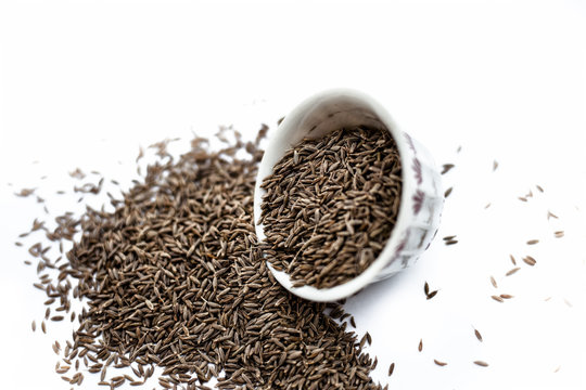 Common cumin or zeera or jeera in a bowl isolated on white.