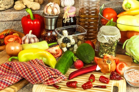 Preparation of vegetable salad in the kitchen. Fresh vegetables on a kitchen board. Healthy diet food.