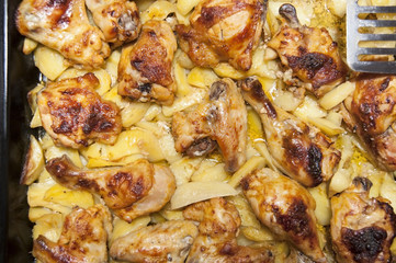 Fried potatoes with fried wings and chicken thighs baked at home