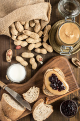 Fototapeta na wymiar Homemade Healthy Breakfast. Peanut Butter and Jelly on Dark Wooden Background.