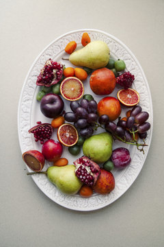 Fresh fruit platter with mini kiwis, pomegranate, grapes and pears