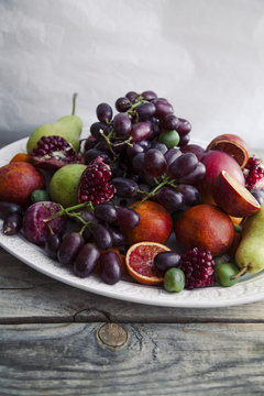 Fresh fruit platter with pomegranate, grapes and pears