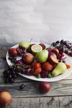 Fresh fruit platter with pomegranate, grapes and pears
