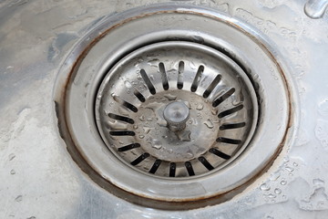 Drain hole with plug in the metal sink