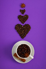 Cup of coffee seeds and coffee hearts with spices