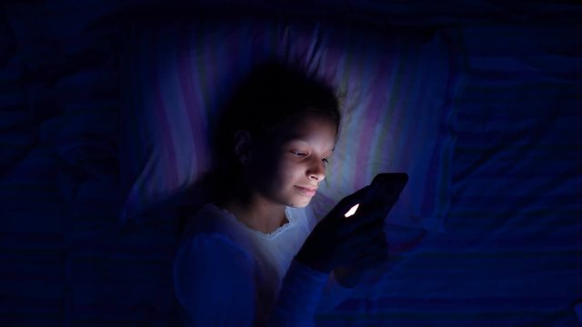 digital modern device addiction. gadget night sleeplessness. young caucasian girl browsing chatting playing serfing network with tablet bed. mobile phone apps.