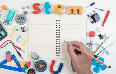 STEM Education. Science Technology Engineering Mathematics. STEM word on book with education equipments for background.
