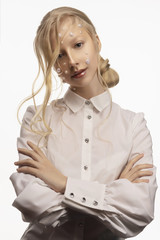 Portrait of a beautiful smiling blonde teenage girl. Conceptual makeup decorated with white pearls...