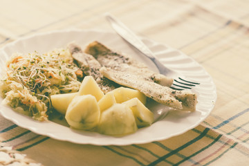 Dinner meal fish with salad and potatoes