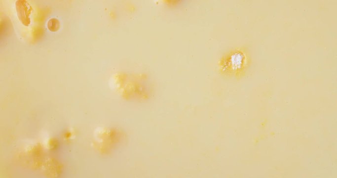 Top close view of fresh creamy homemade banana cream pudding with bubbles popping after mixing.