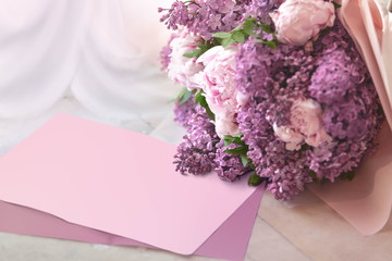 Wedding Bouquet from a lilac and peonies on a table from marble with the place for the text or the...
