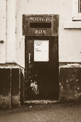 Old English Posting Box Built Into Wall in Sepia Tone, vertical photography