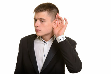 Studio shot of young businessman listening