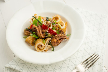 Fresh Fried Squids, Chili Pepper and Mint Leaves on White Plate