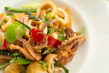 Fresh Fried Squids, Chili Pepper and Mint Leaves on White Plate