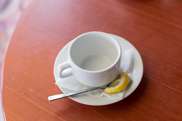 white Cup on saucer. teacup. Cup on saucer with lemon