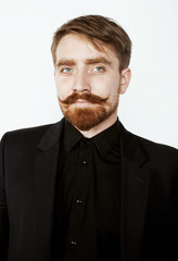 young red hair man with beard and mustache in black suit on white background