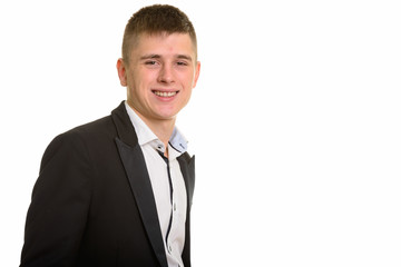 Studio shot of young happy businessman smiling