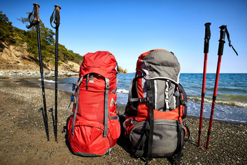 Camping with backpacks on the seashore in the summer.