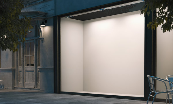 Blank Shop Window In The Night Street With Light On The Frame. 3d Rendering