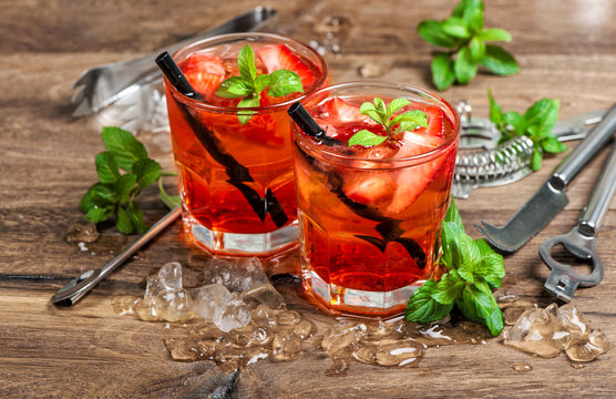 Summer drink Red cocktail strawberry mint leaves ice