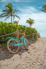 Blue, urban, stylish bike on Miami Beach, Florida. Bicycle adventure trip tour outdoors background. Sandy beach trail