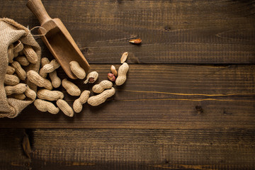 Organic Peanuts in Shells on Rustic Wooden Background with Copy Space