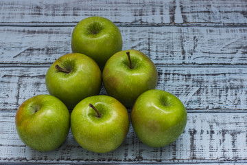 Fresh green apples on vintage wooden background. Detox, diet or healthy food concept