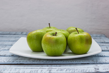 green apples on a wooden background